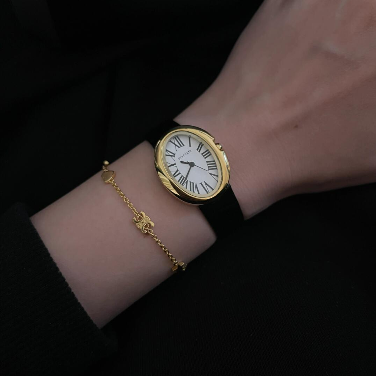 Golden Grace Timepiece: Oval Roman Numeral Dial with Black Strap